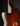 Back view of an electric guitar on a dark background