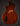 Back view of an electric guitar on a dark background