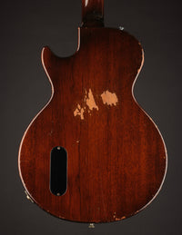 Back view of an electric guitar on a dark background
