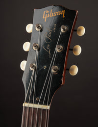 Gibson Les Paul guitar headstock on a dark background