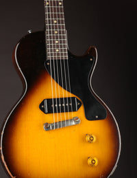 Electric guitar with a sunburst finish on a dark background
