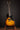 Electric guitar on a stand against a dark background