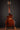 Electric guitar on a stand against a dark background