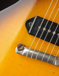 Close-up of a guitar's bridge and P90 pickup