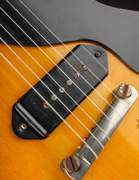 Close up of bridge and pickup on a sunburst electric guitar 