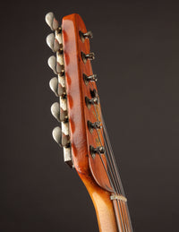 Close-up of a guitar headstock on a dark background