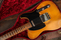 Electric guitar in a case with a red interior