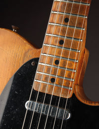 Telecaster guitar with a blonde finish on a dark background