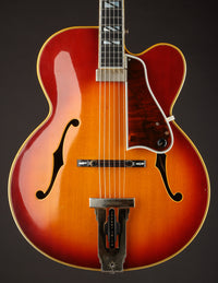 Vintage Johnny Smith archtop guitar with a sunburst finish on a dark background