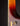 Close up of finish wear on the neck of a Gibson Johnny Smith archtop guitar with a sunburst finish on a dark background
