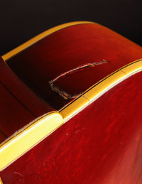Close up of a repaired crack on a vintage Johnny Smith archtop guitar with a sunburst finish