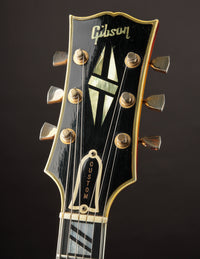 Gibson guitar headstock on a dark background