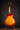 Vintage Johnny Smith archtop guitar with a sunburst finish on a stand against a dark background