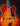 Close up of a vintage Johnny Smith archtop guitar with a sunburst finish on a dark background