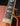 Close up of fingerboard and neck pickup on a vintage Johnny Smith archtop guitar with a sunburst finish on a dark background