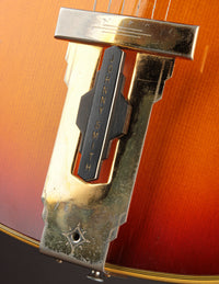 Close up of tailpiece on a Johnny Smith archtop guitar with a sunburst finish