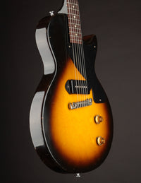 Electric guitar with a sunburst finish on a black background
