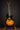 Electric guitar on a stand against a dark background