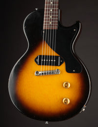 Electric guitar with a sunburst finish on a black background