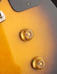 Close-up of control knobs on an electric guitar 