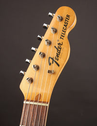 Fender Telecaster guitar headstock on a dark background