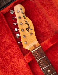 Fender Telecaster guitar headstock on a red background
