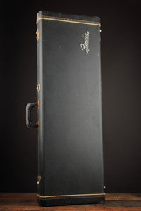Black guitar case with a Fender logo on a dark background