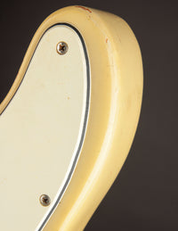 Close-up of a guitar's pickguard with a dark background