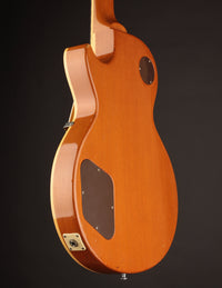 Close-up of an electric guitar on a dark background, side view
