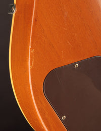 Close-up of an electric guitar on a dark background