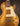 Gold electric guitar with a dark background