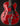 Red electric guitar with Guild logo on a black background