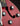 Close-up of a red guitar with control knobs and Guild logo.