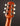 Close-up of a guitar headstock with tuning pegs on a dark background