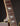 Close-up of a guitar neck with fretboard and strings on a dark background