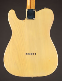 Back view of a Blonde 1953 Fender Telecaster guitar on a dark background