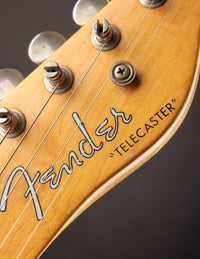 Close up of logo on a vintage Fender Telecaster guitar 