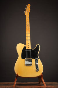 1953 Fender Telecaster guitar on a stand against a dark background