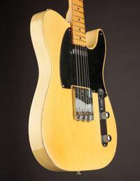 Side view of Blonde 1953 Fender Telecaster against a dark background