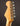 Close-up of a guitar headstock with tuning pegs on a dark background