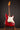 1964 candy apple red Fender Stratocaster  electric guitar on a stand against a dark background