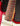 Close-up of a 1964 candy apple red Fender Stratocaster neck and fretboard against a dark background