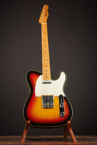 Close-up of a Sunburst 1968 Fender Telecaster Custom guitar headstock on a dark background 