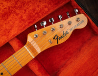 Close-up of a Sunburst 1968 Fender Telecaster Custom guitar headstock, in original case with red lining