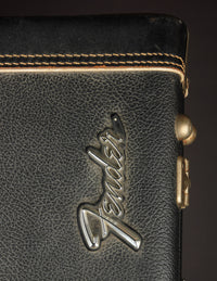 Close up of Fender logo on a vintage electric guitar case