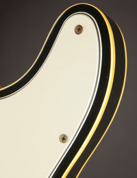 Close-up of a white pickguard and binding  on a 1968 Fender Telecaster