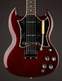 Red electric guitar with a dark background