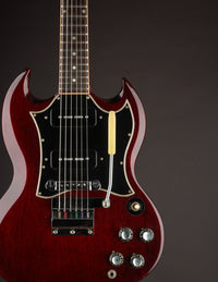 Red electric guitar with a dark background