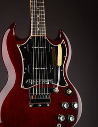 Red electric guitar with a dark background