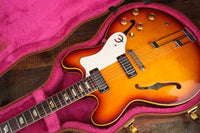 Vintage Epiphone Riviera artfully displayed in its open case.
